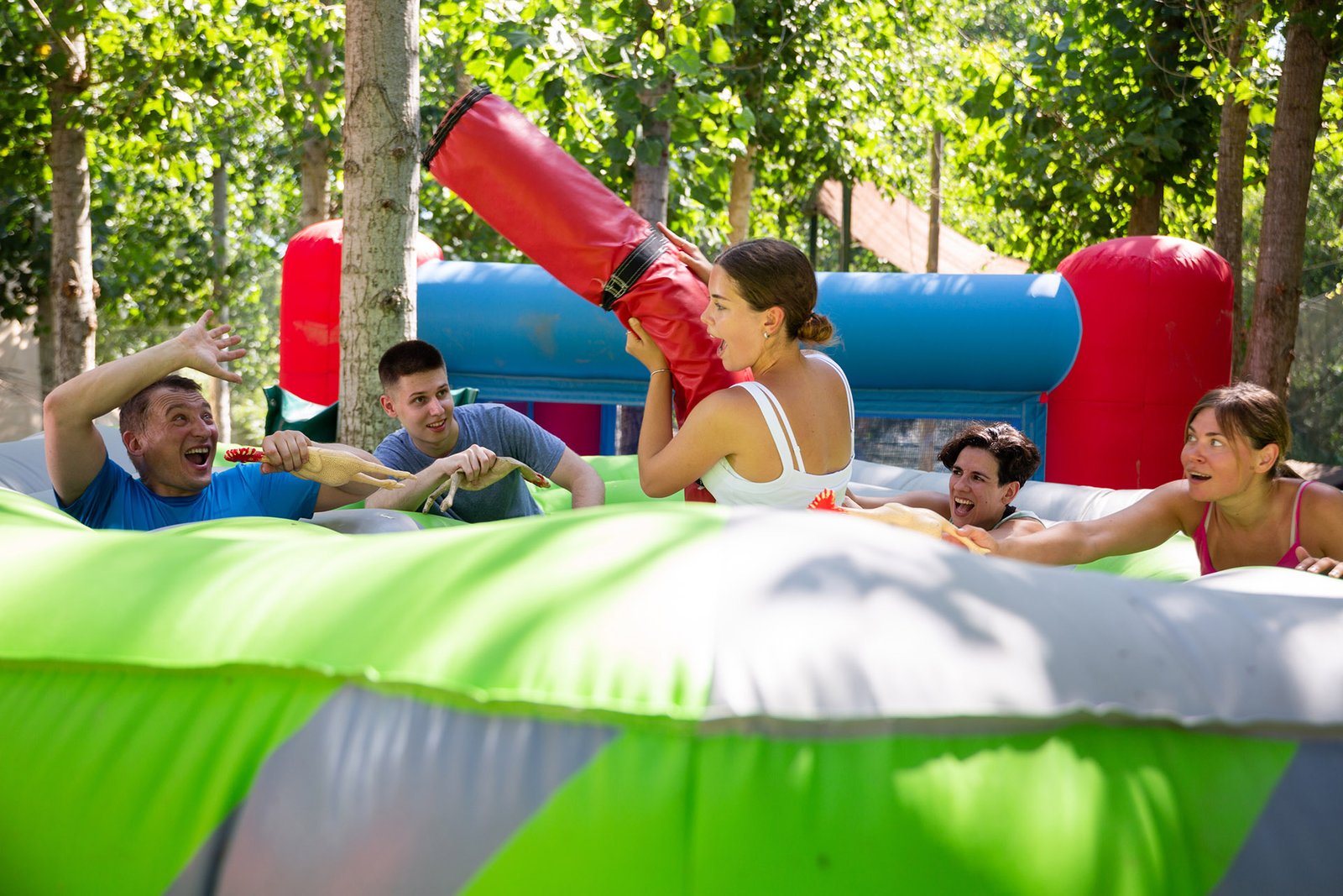 Men and women playing interesting game in adventure park